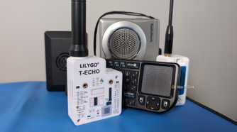 Several small electronic devices including LoRa radios, a mini keyboard, a cassette recorder, and a Raspberry Pi computer.