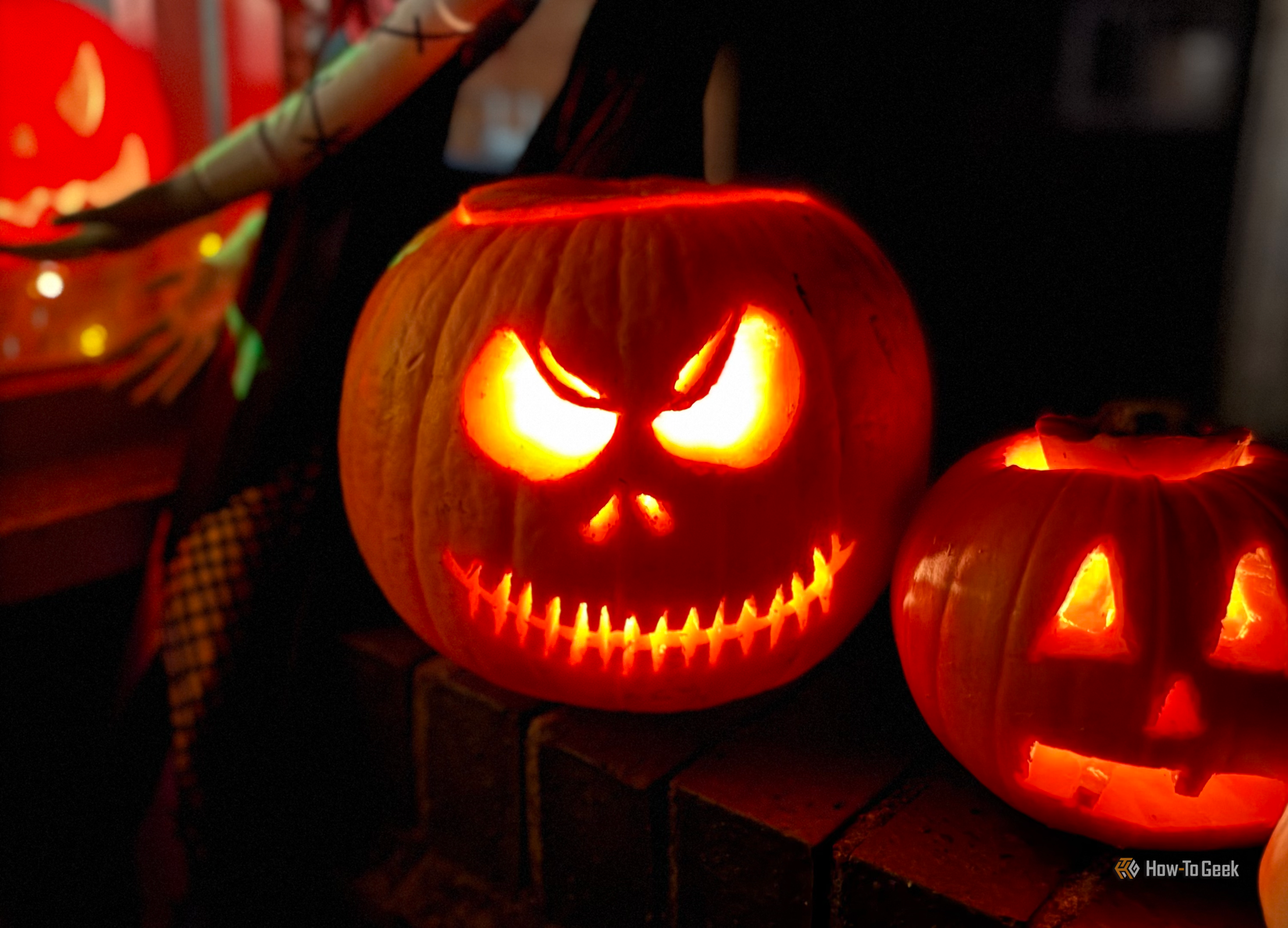 Spooky jack-o-lanterns outside a home on Halloween.