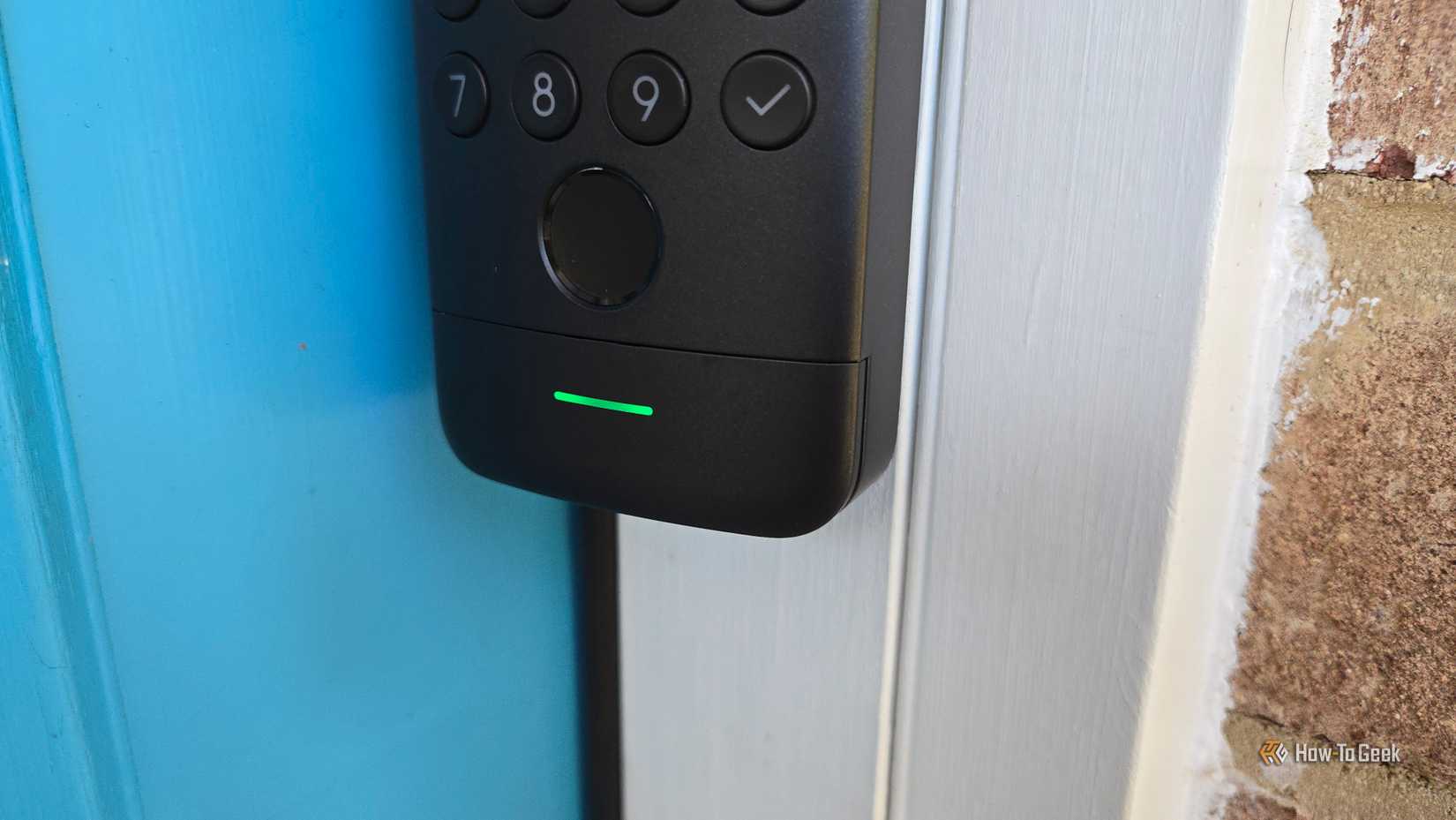 The green indicator light on a SwitchBot Keypad Vision.
