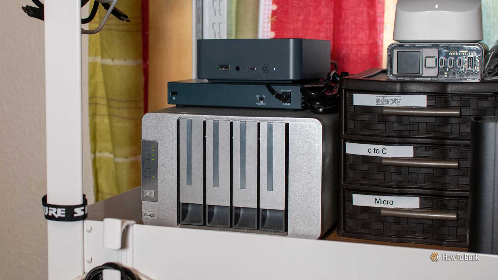 A Beelink mini PC and Terramaster NAS together on a shelf.