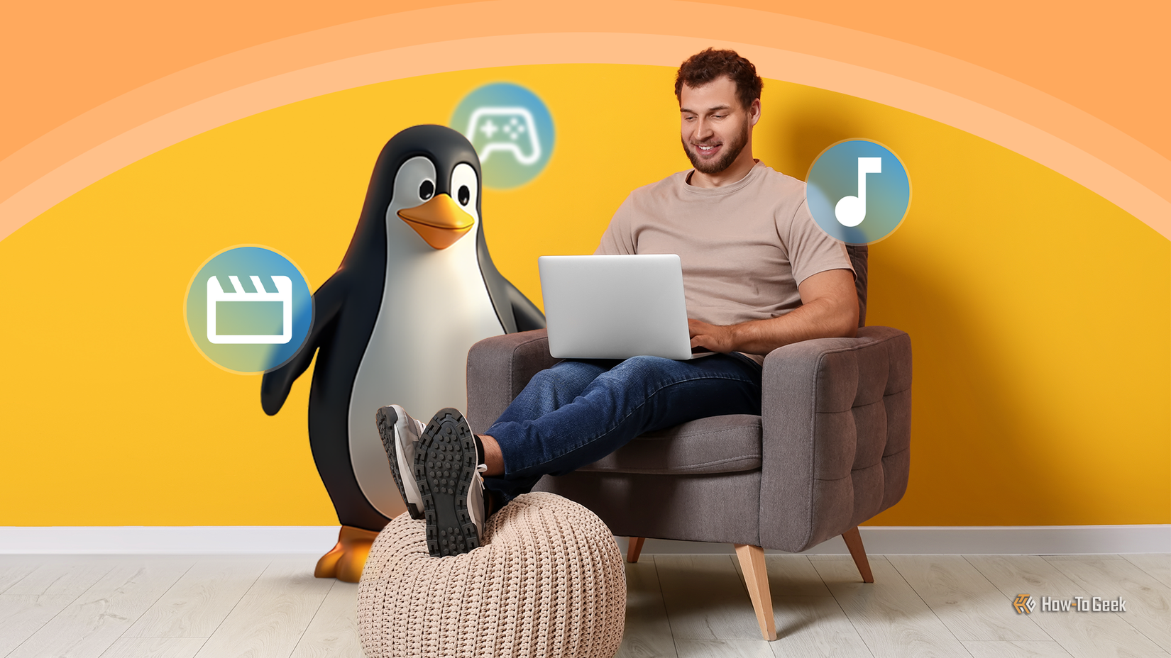 A man sitting comfortably on an armchair using a laptop, with the Linux mascot Tux standing beside him and floating icons representing media, gaming, and music.