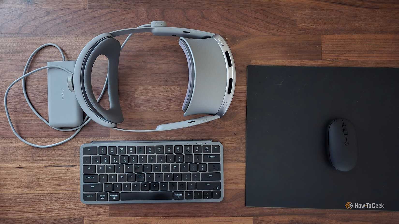 A Samsung Galaxy XR headset next to a Bluetooth keyboard and mouse.