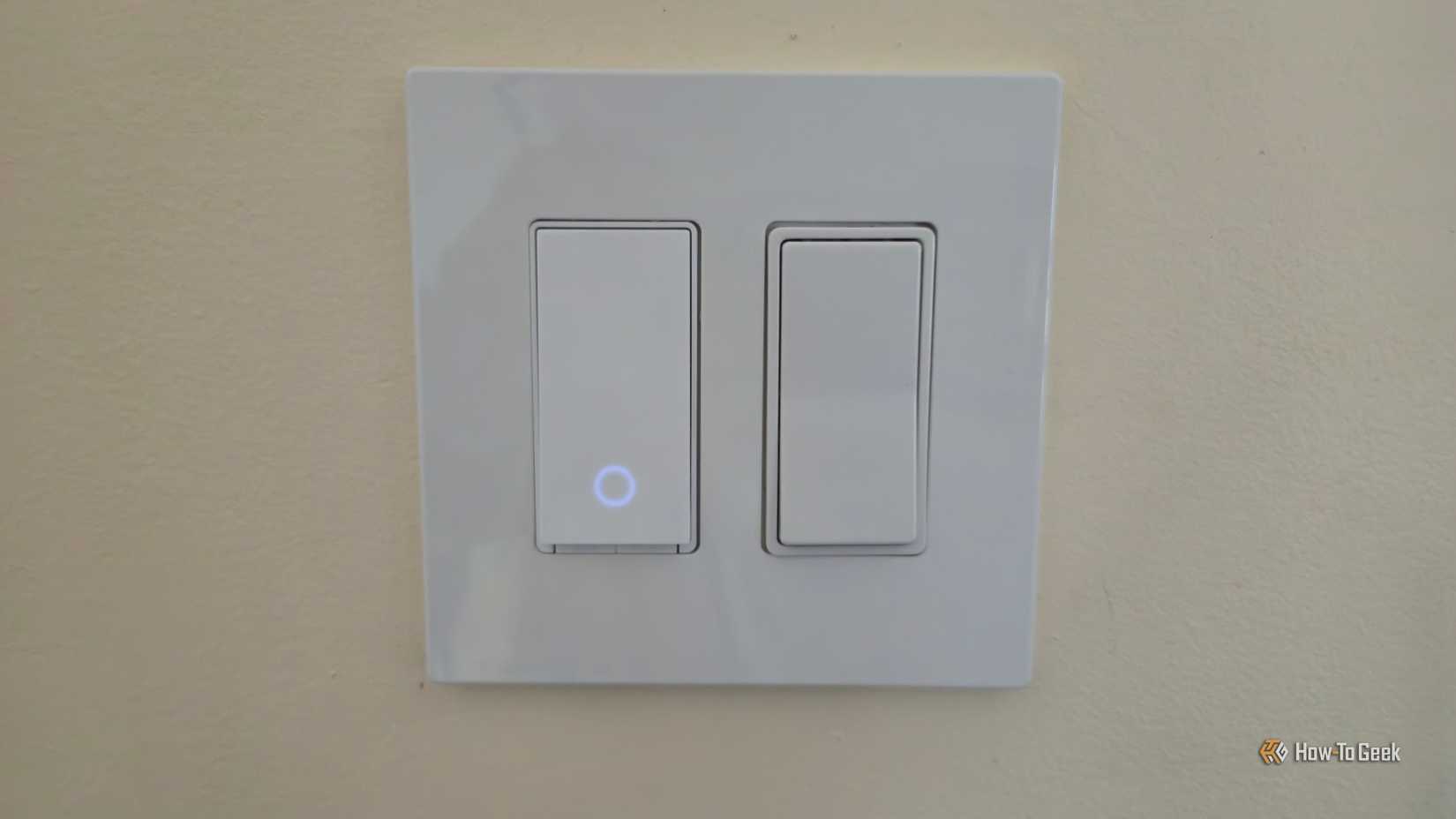 A Tapo light switch next to an Eaton rocker switch.