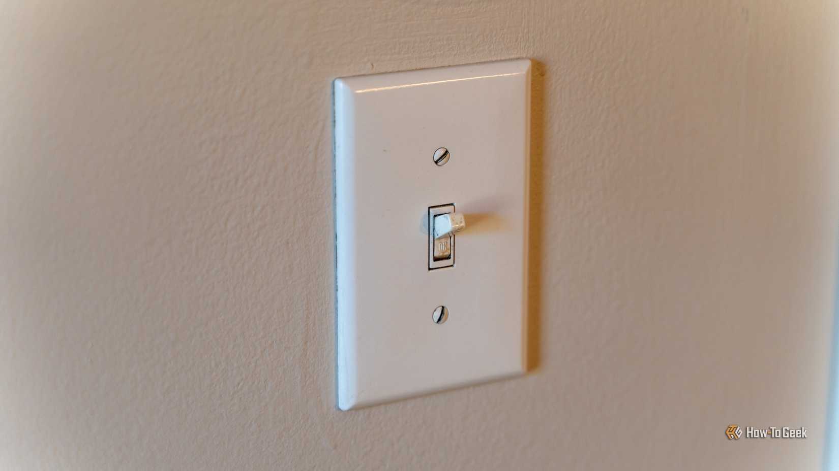 A toggle light switch on a wall.