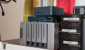 Angled view of a Beelink mini PC and Terramaster NAS on a shelf.