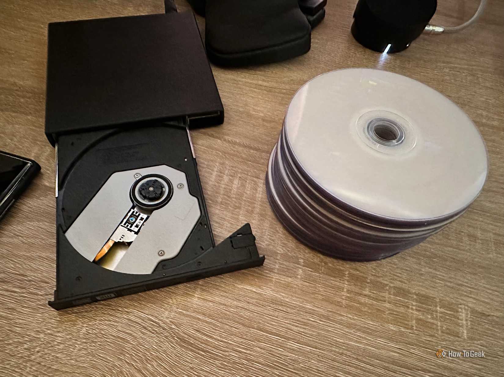 DVD burner with pile of blank discs.