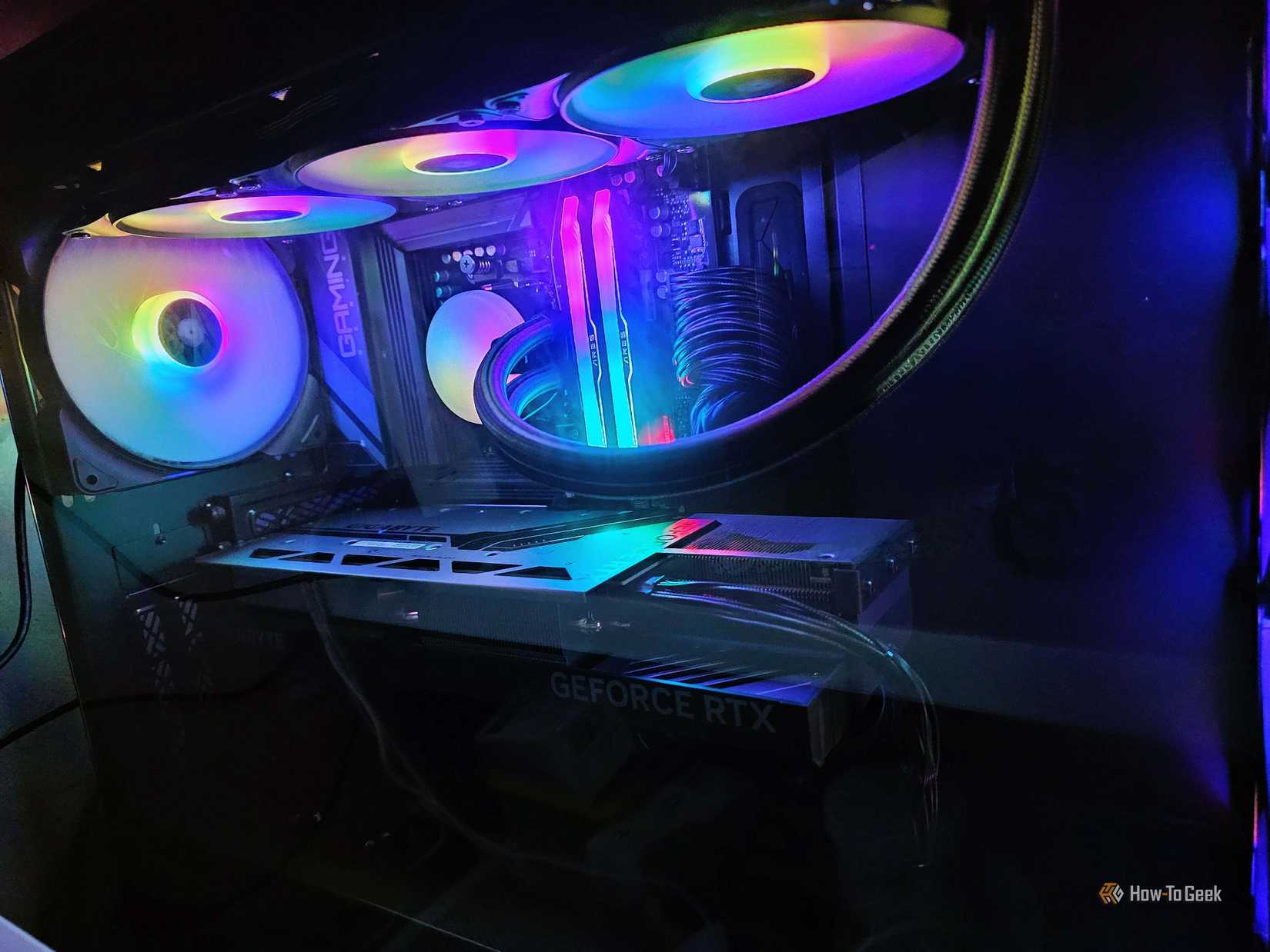 The inside of a gaming PC, showing the AIO cooler, the GPU, and a case fan.