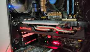 An old AMD RX 580 inside of a dusty old gaming pc.