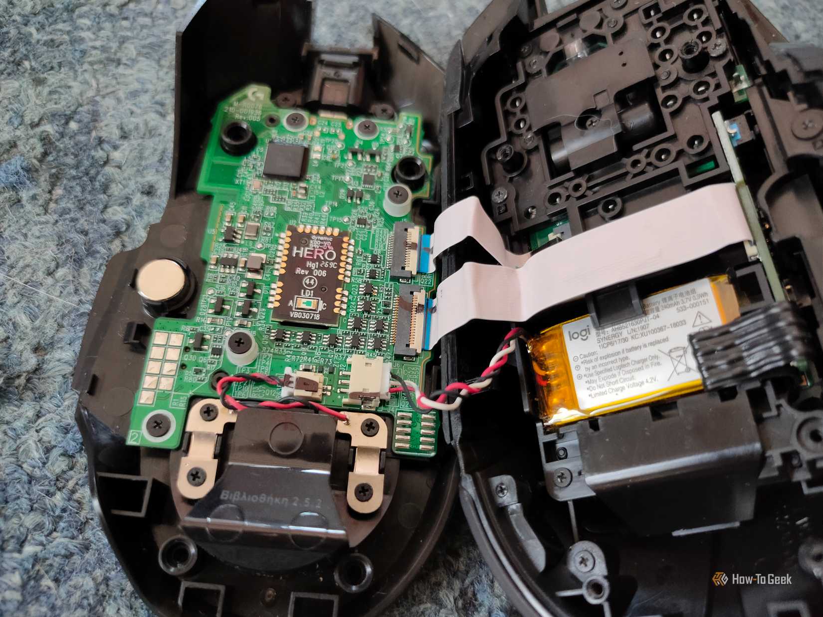 A disassembled Logitech G502 mouse.