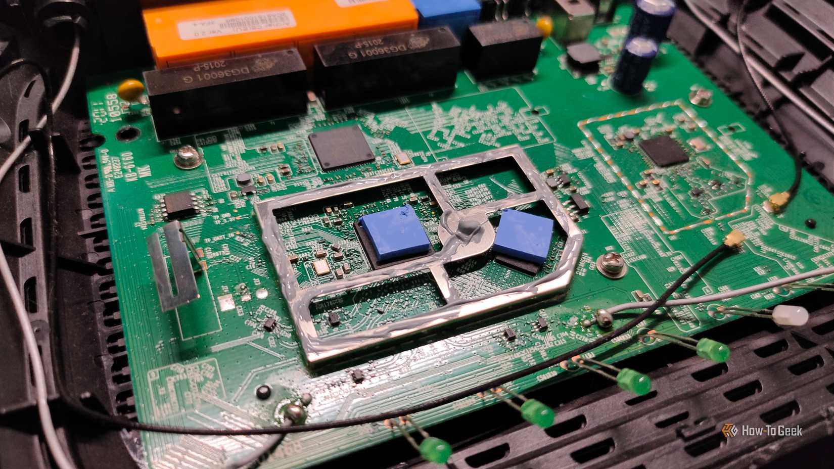 Thermal pads and some thermal paste inside a Wi-Fi router.