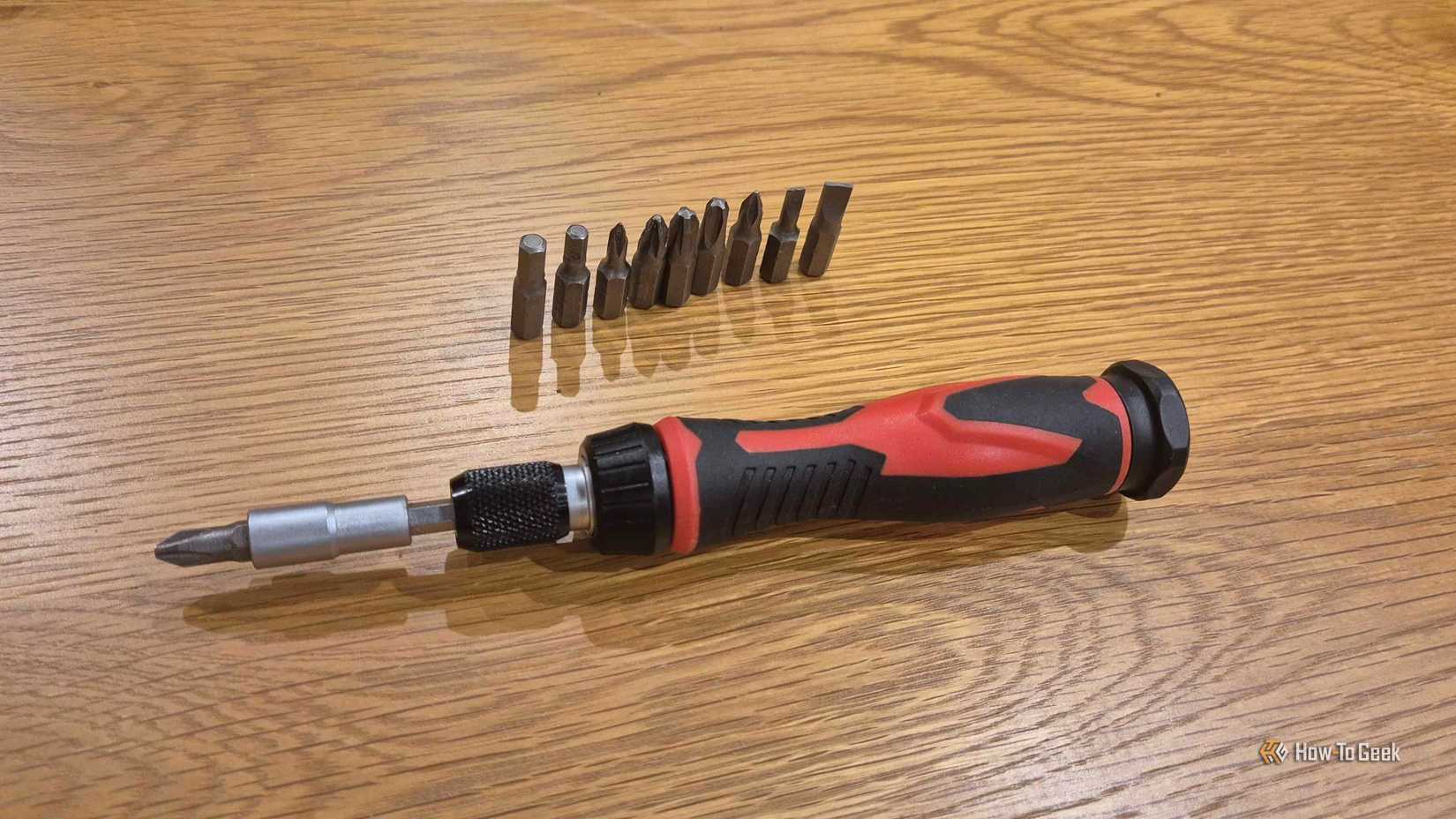 A magnetic screwdriver on a wooden table.