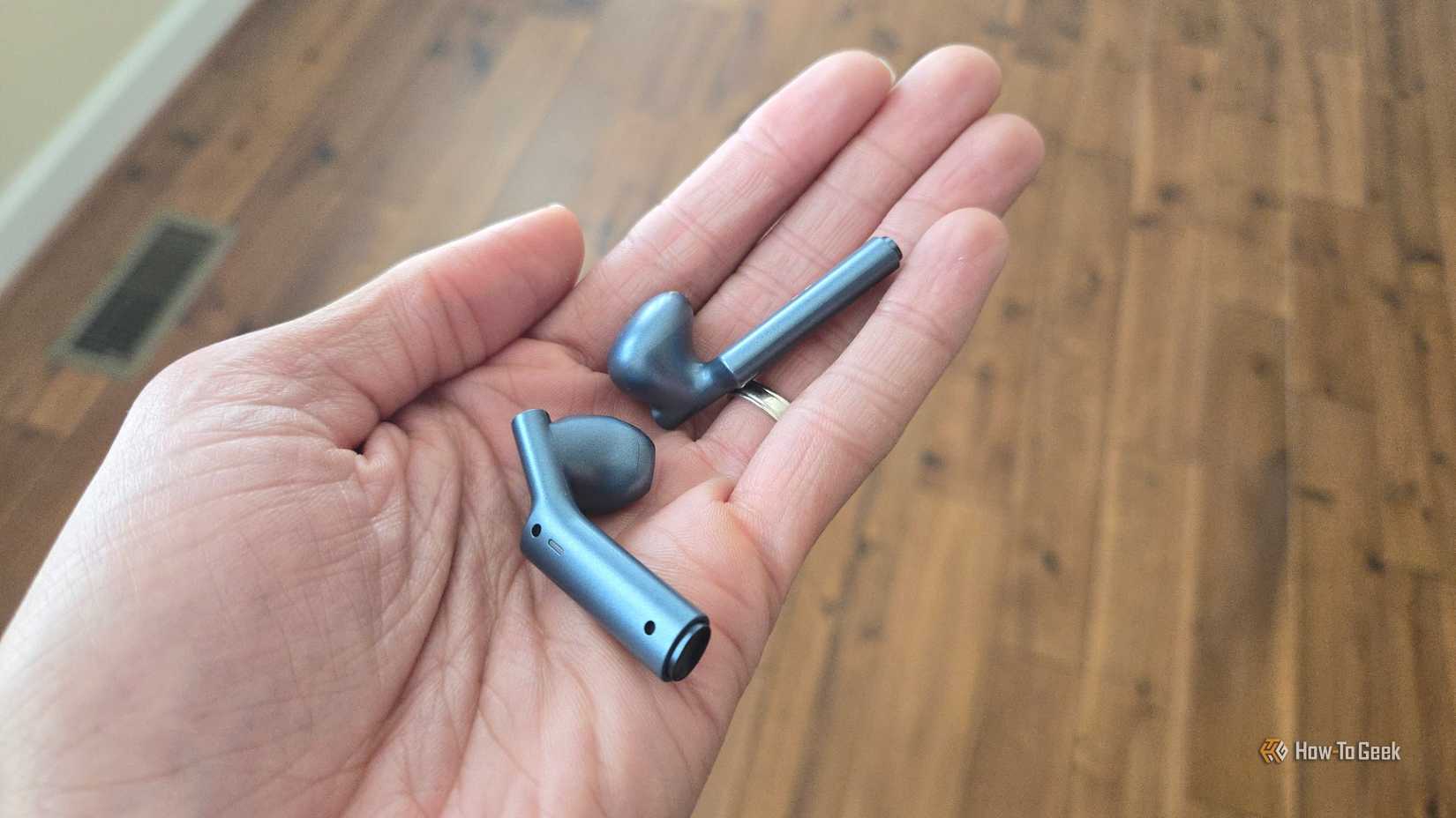 Timekettle W4 AI translator earbuds in a hand