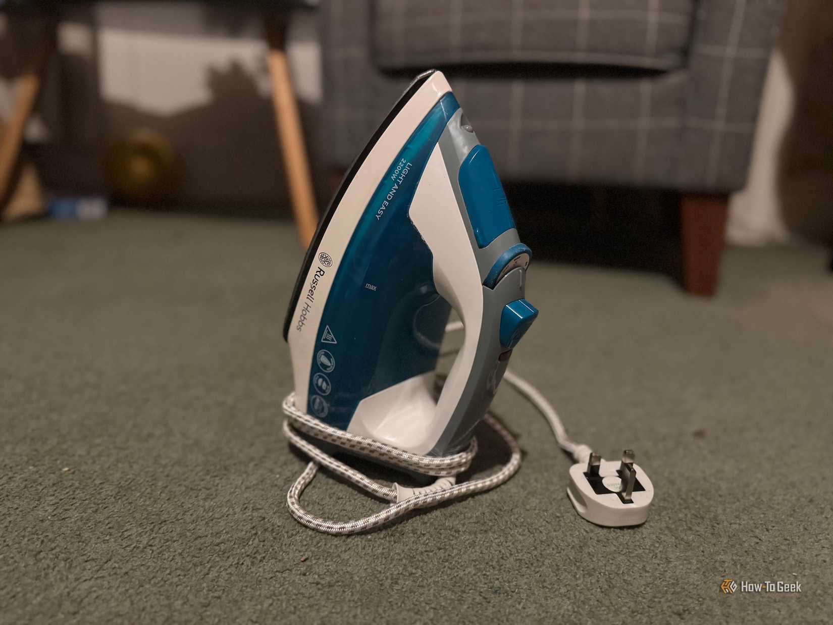 An iron sitting on a floor.