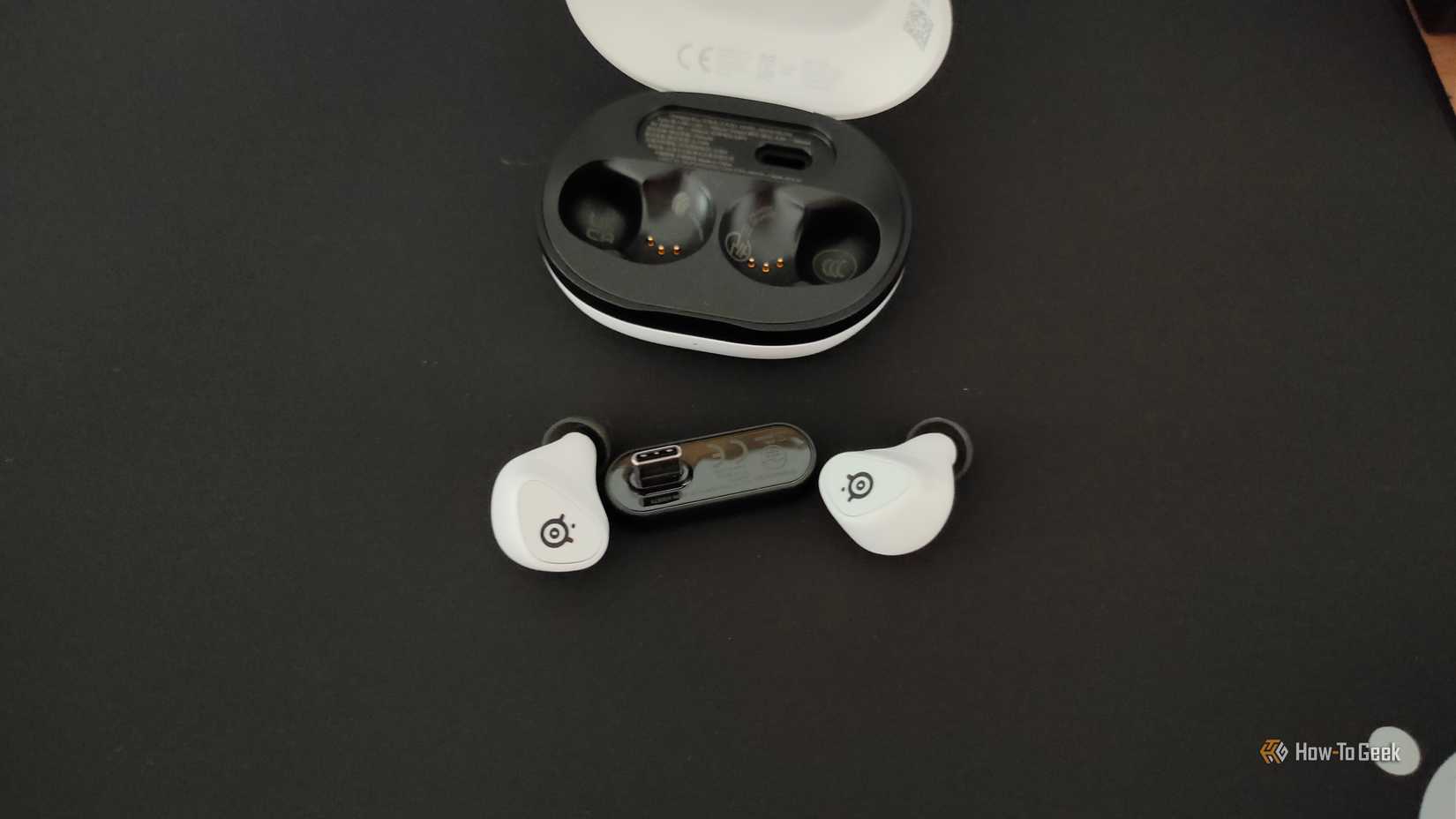 The SteelSeries Arctis GameBuds wireless gaming earbuds outside their case.