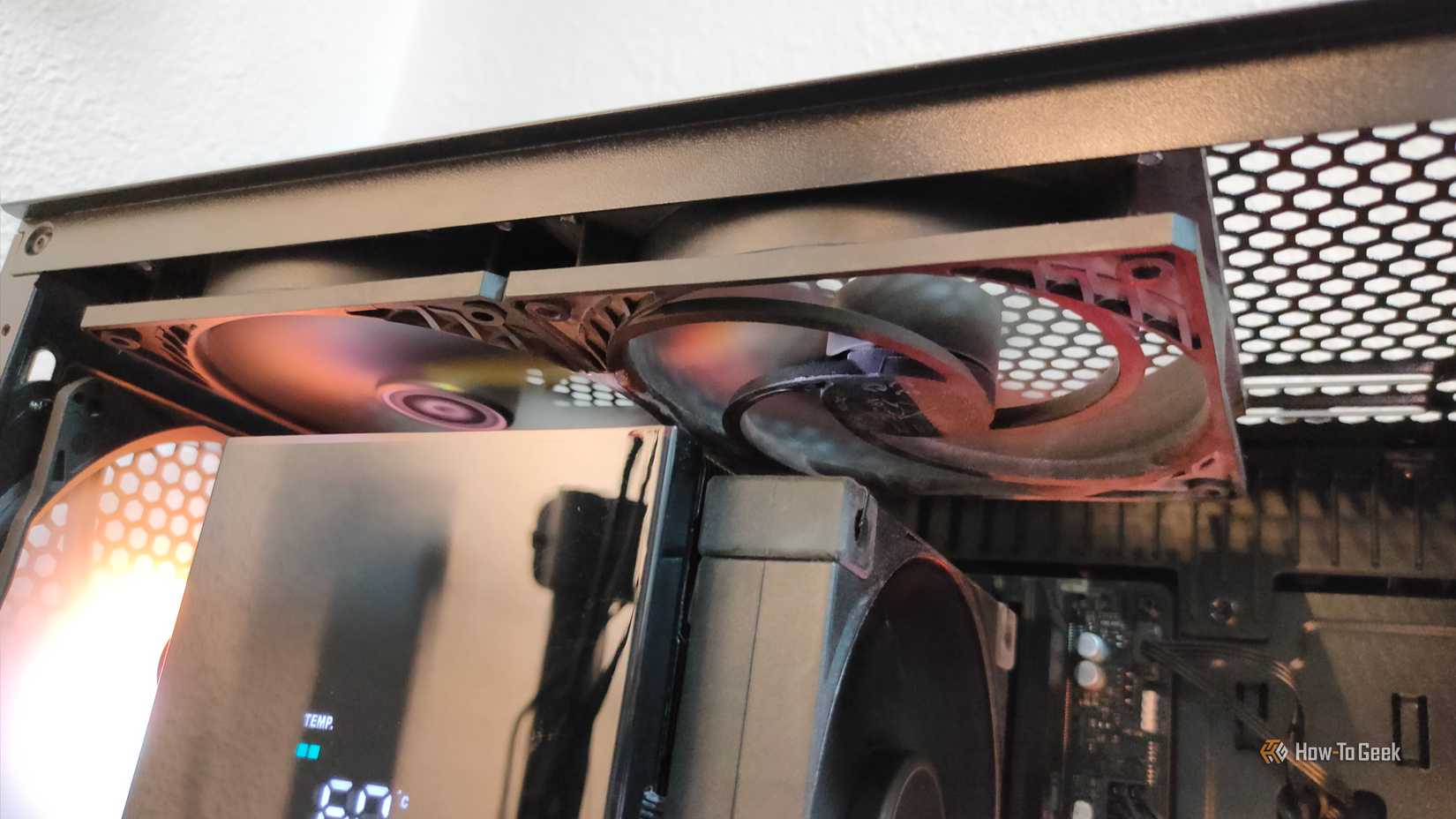 An intake next to an exhaust fan in a PC.