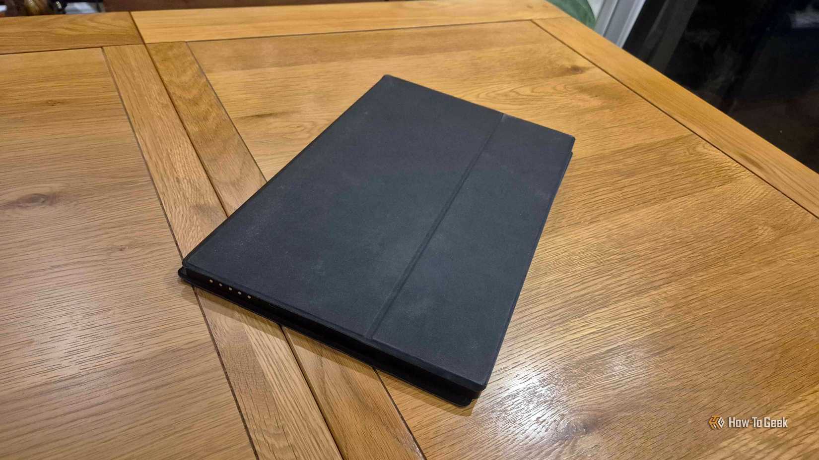 The Uperfect portable monitor folded up on a table.