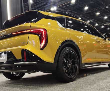 Static rear 3/4 shot of a yellow 2026 Kia K4 Hatchback.