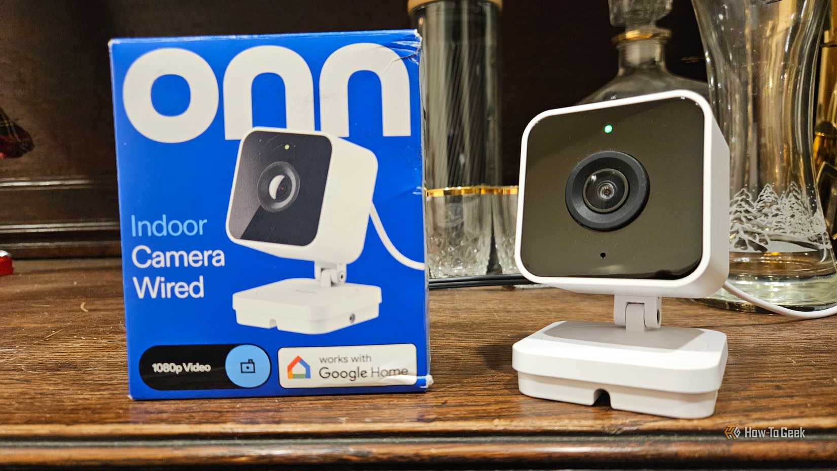 The Onn wired indoor security camera next to its box.