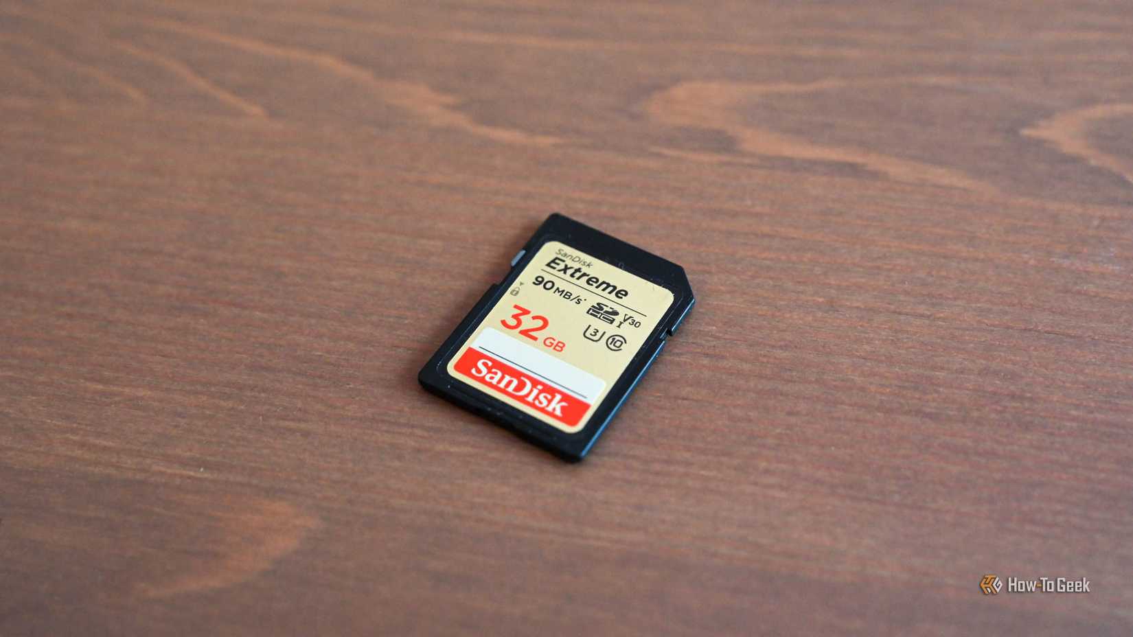 A 32 GB SanDisk SD card lying on a table.