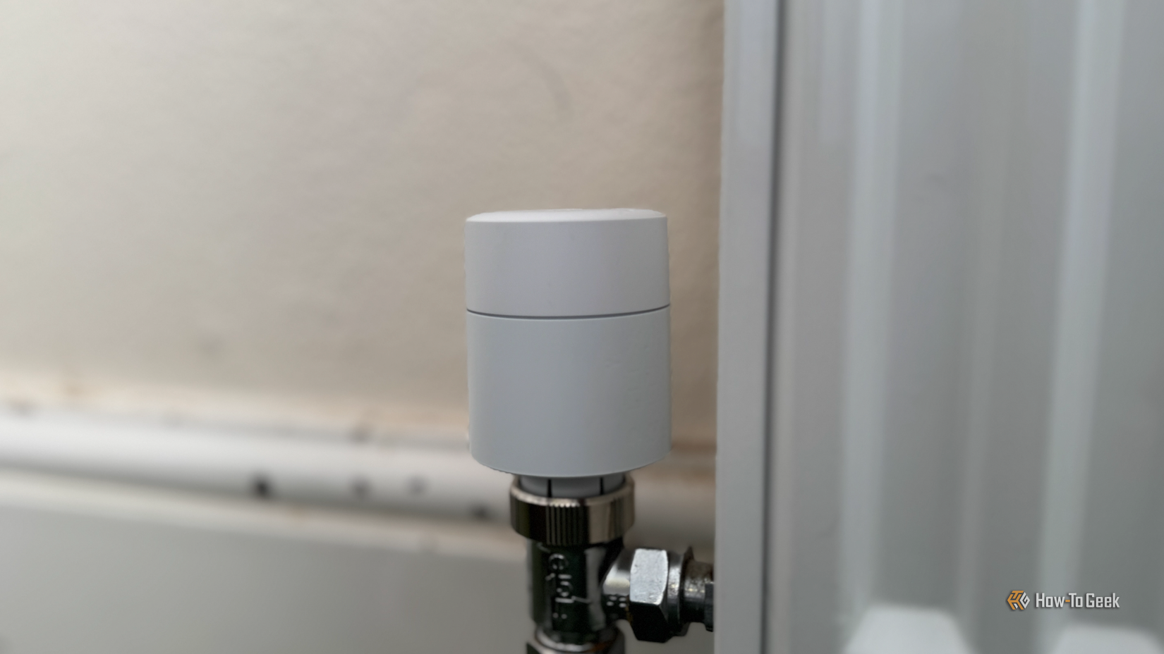 A Tado smart radiator thermostat on a radiator.