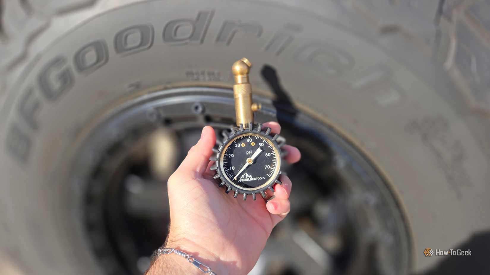 tire pressure guage in front of a tire