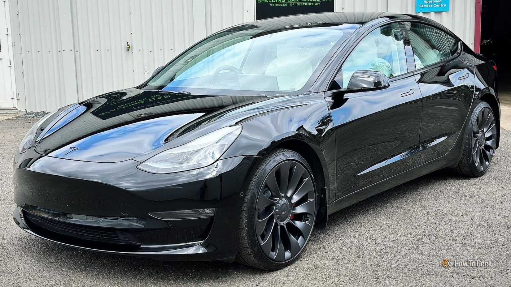 Static front 3/4 shot of a black 2021 Tesla Model 3 Performance.