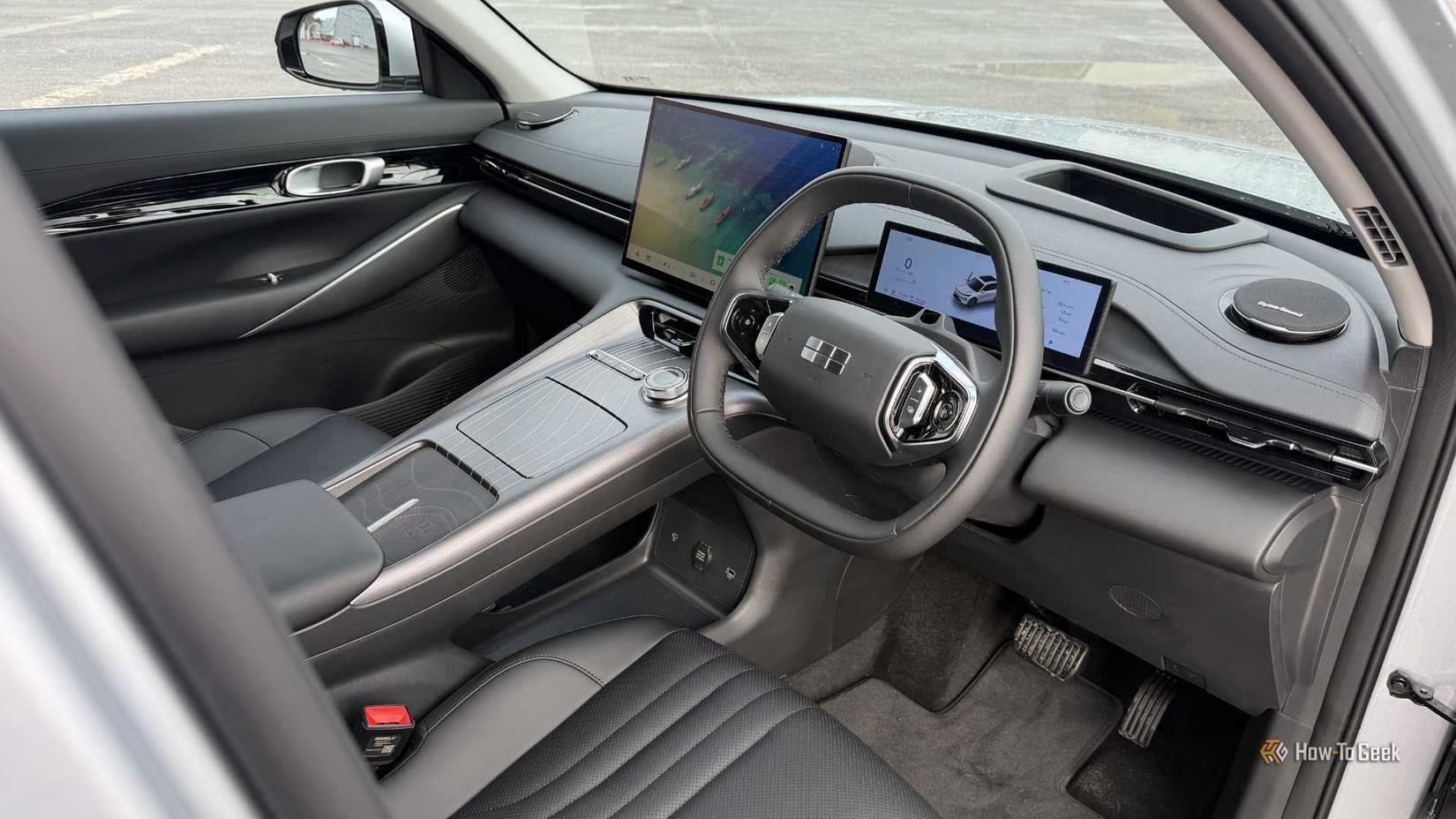 Shot inside the cabin of a 2026 Geely Starray EM-i, showing the driver and passenger black leather seats and dashboard.
