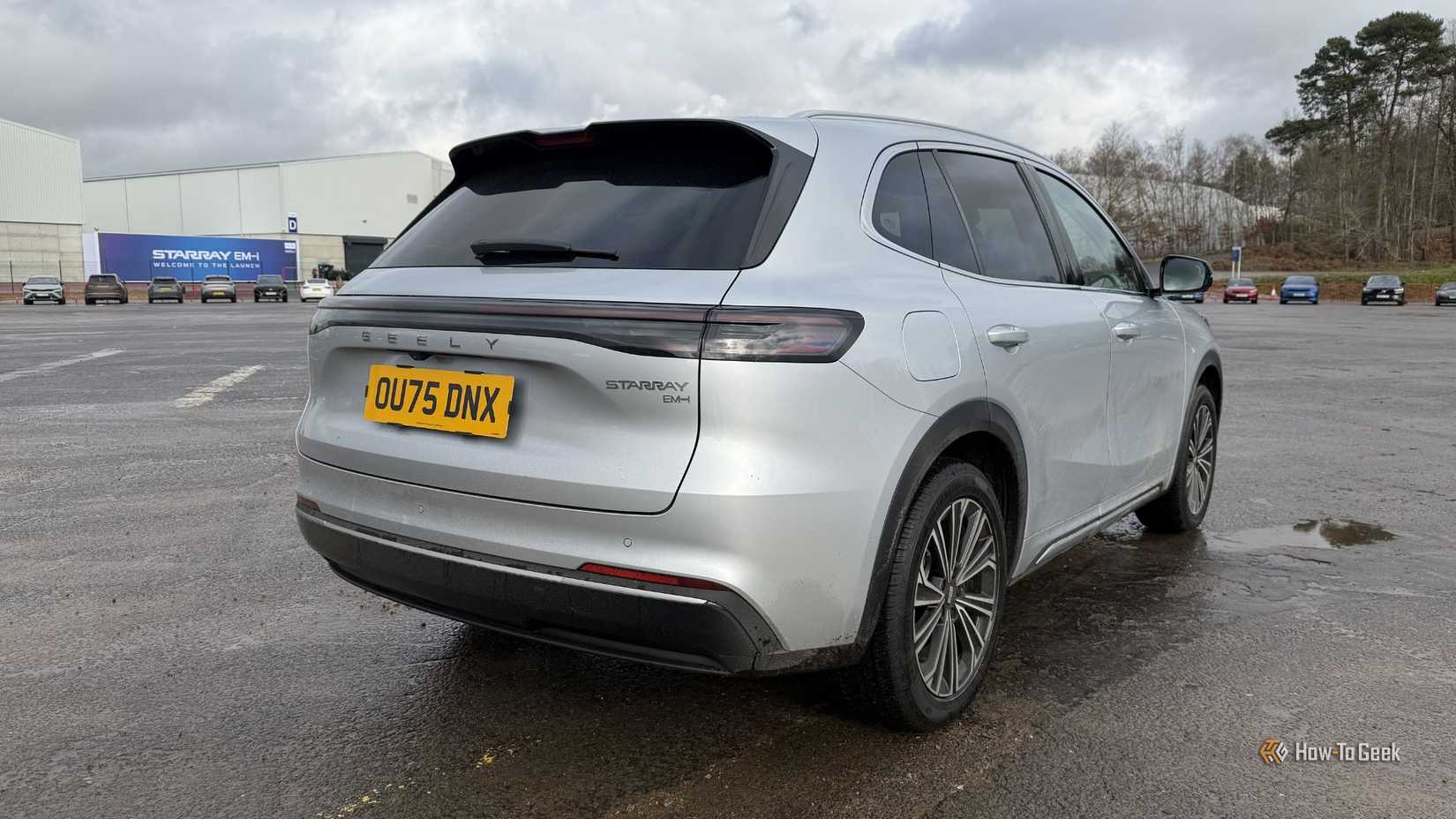 Static rear 3/4 shot of a silver 2026 Geely Starray EM-i.