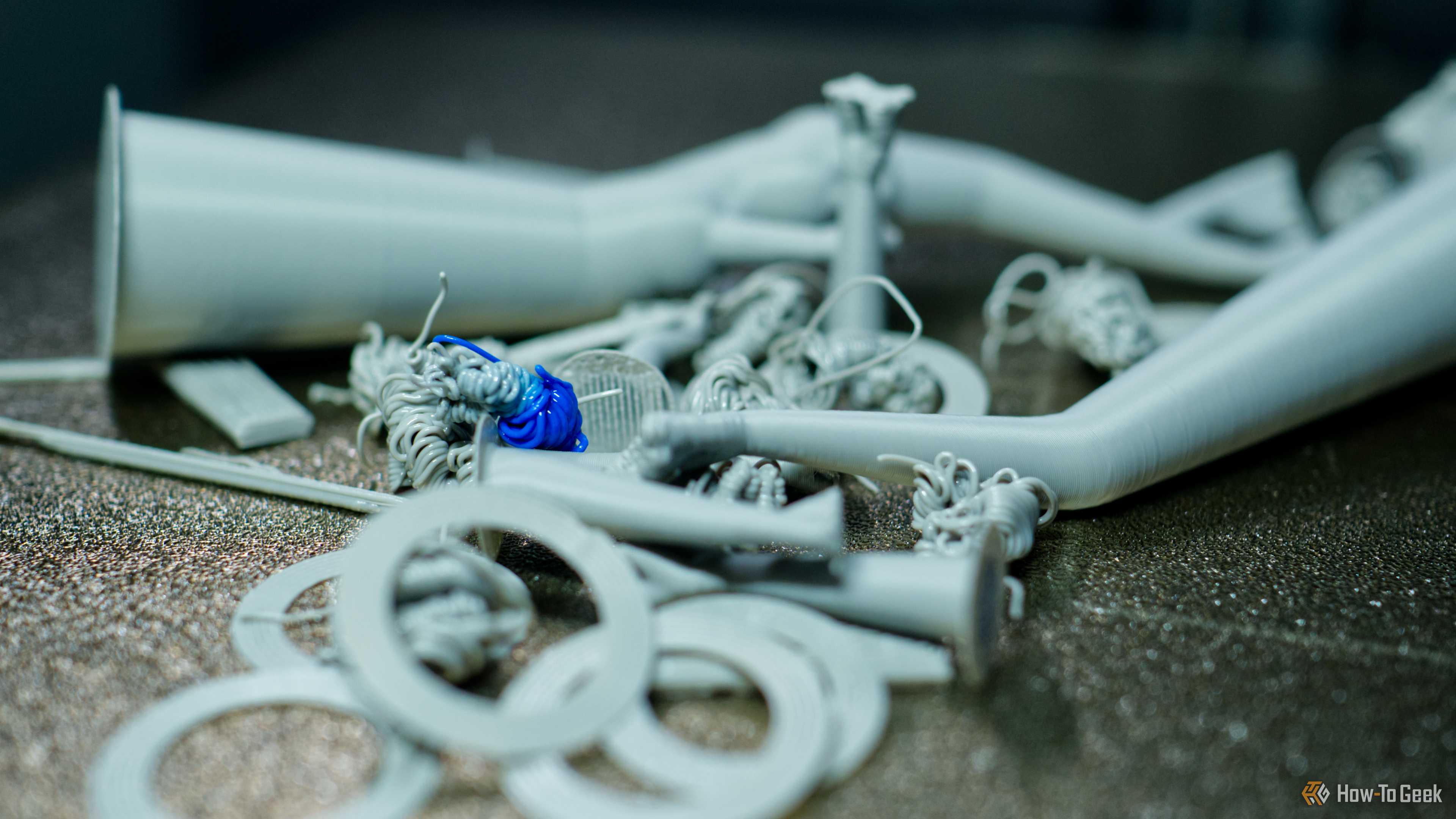 3D printer filament poop on a Bambu Lab P2S print bed.