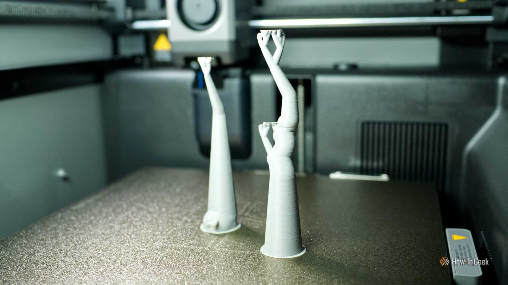 3D printing tree supports inside a Bambu Lab P2S 3D printer.