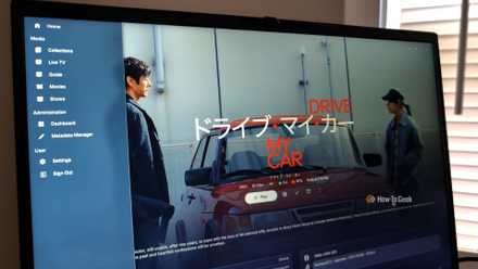 A laptop screen showing the movie Drive My Car in a Jellyfin web interface with ElegantFin theme applied.