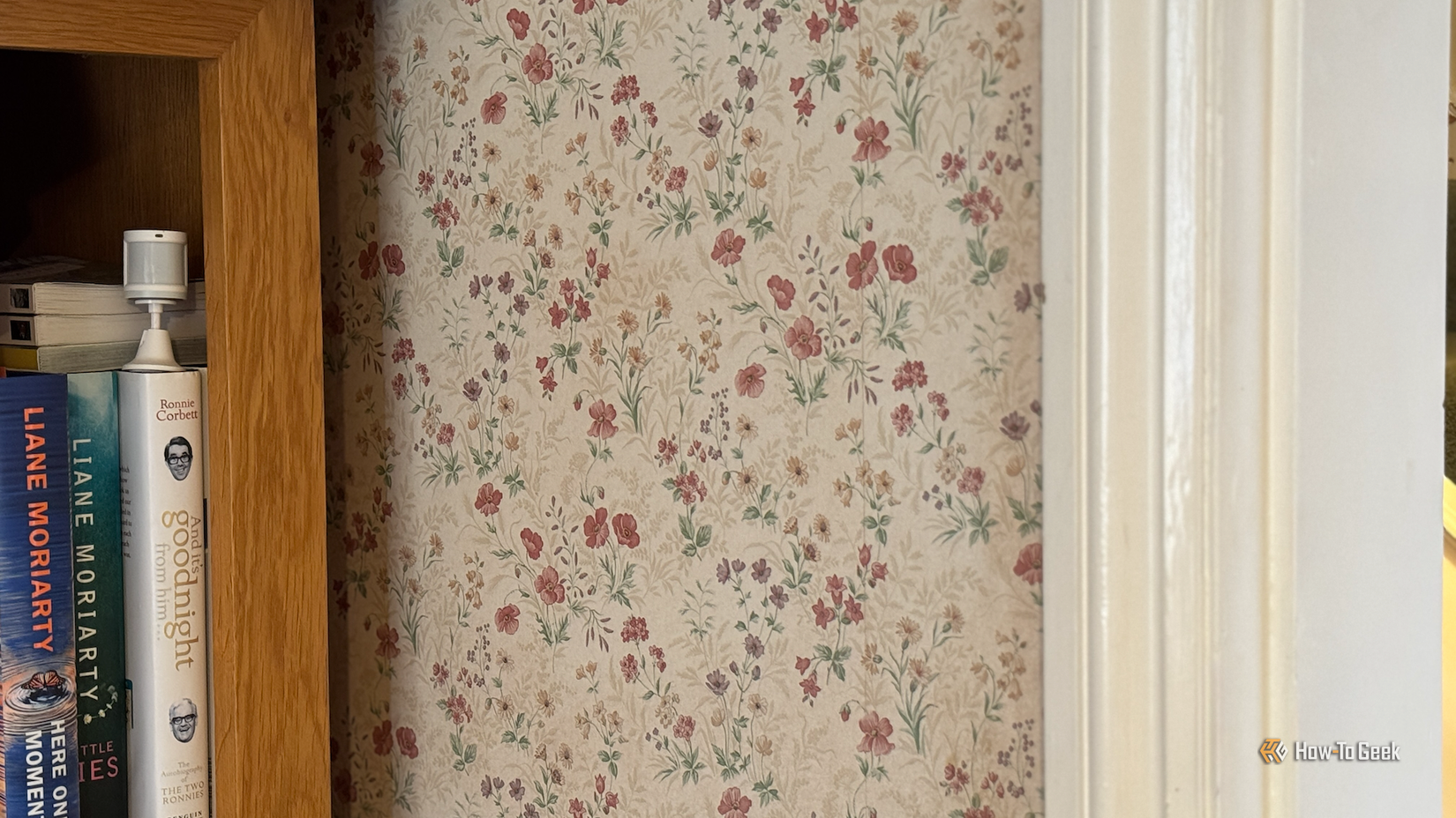 A motion sensor pointing across the threshold of a doorway into a room.