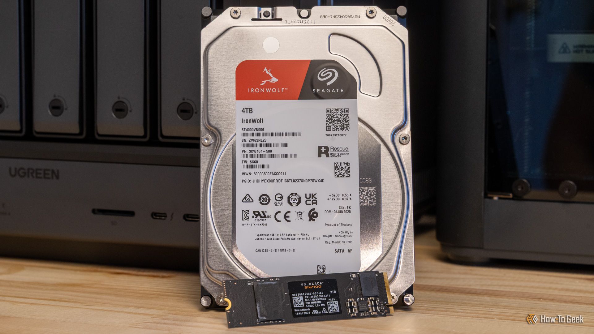 A Seagate IronWolf 4TB hard drive and a WD Black NVMe SSD side by side in front of the Ugreen iDX6011 Pro NAS.