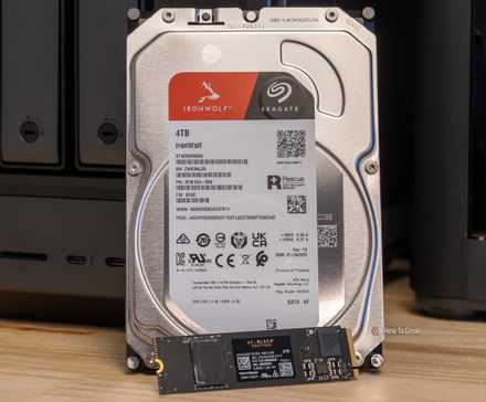 A Seagate IronWolf 4TB hard drive and a WD Black NVMe SSD side by side in front of the Ugreen iDX6011 Pro NAS.