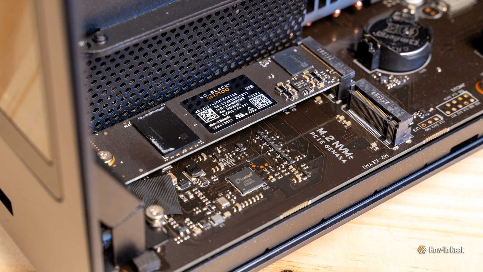 A WD Black SN7100 2TB NVMe SSD installed in one of the M.2 slots on the Ugreen iDX6011 Pro NAS motherboard.