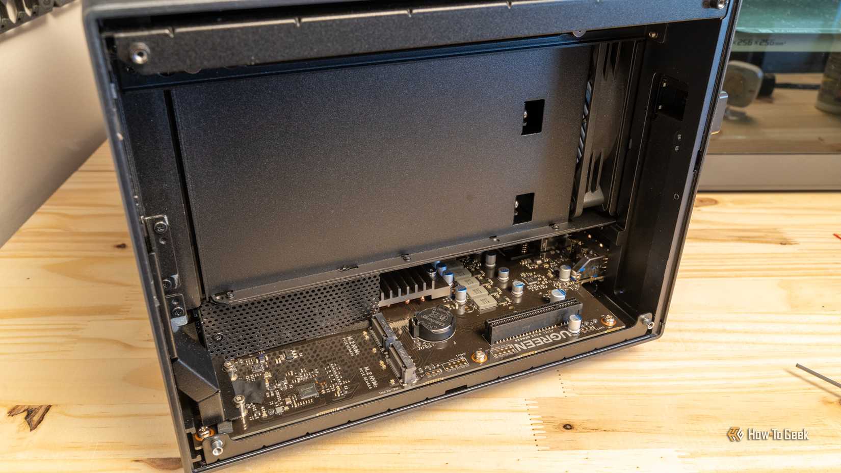 A wide view of the Ugreen iDX6011 Pro NAS internal motherboard showing the heatsink and component layout.