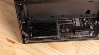 A wide view of the Ugreen iDX6011 Pro NAS motherboard with the M.2 heatsink installed and PCIe slot visible.