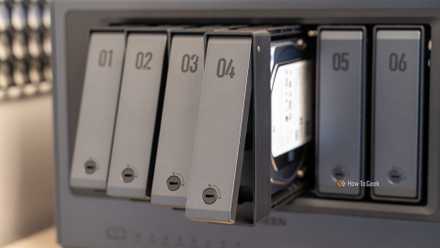 Drive trays removed from the Ugreen iDX6011 Pro NAS show a tool-less tray design and a built-in hard drive.
