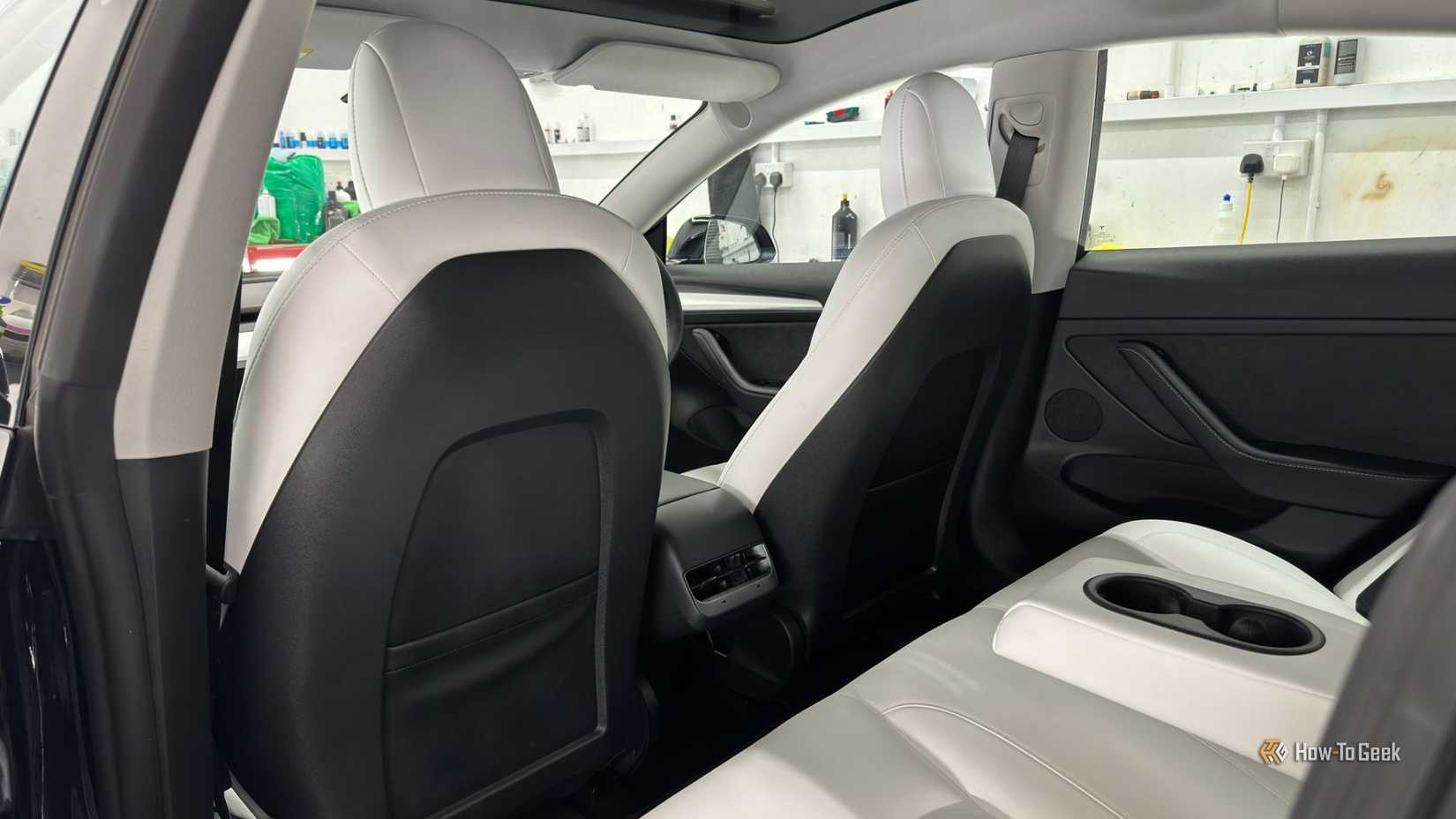 Shot inside the cabin of a 2021 Tesla Model 3 Performance, showing the white interior rear seats.