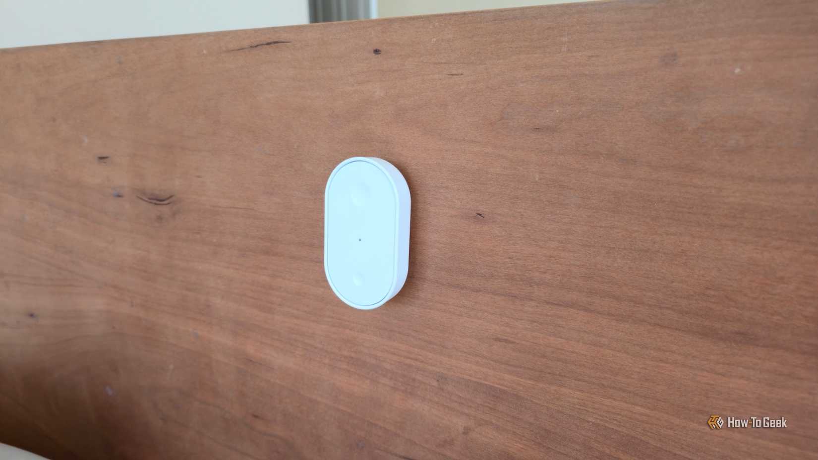 IKEA BILRESA smart button mounted to a bed frame.