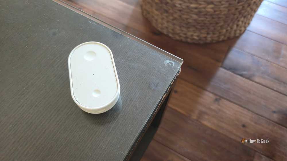 A smart remote on the coffee table puts scene control within reach.
