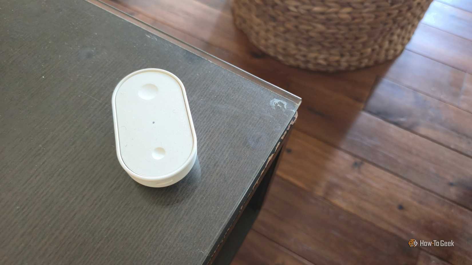 IKEA BILRESA smart remote on a coffee table.