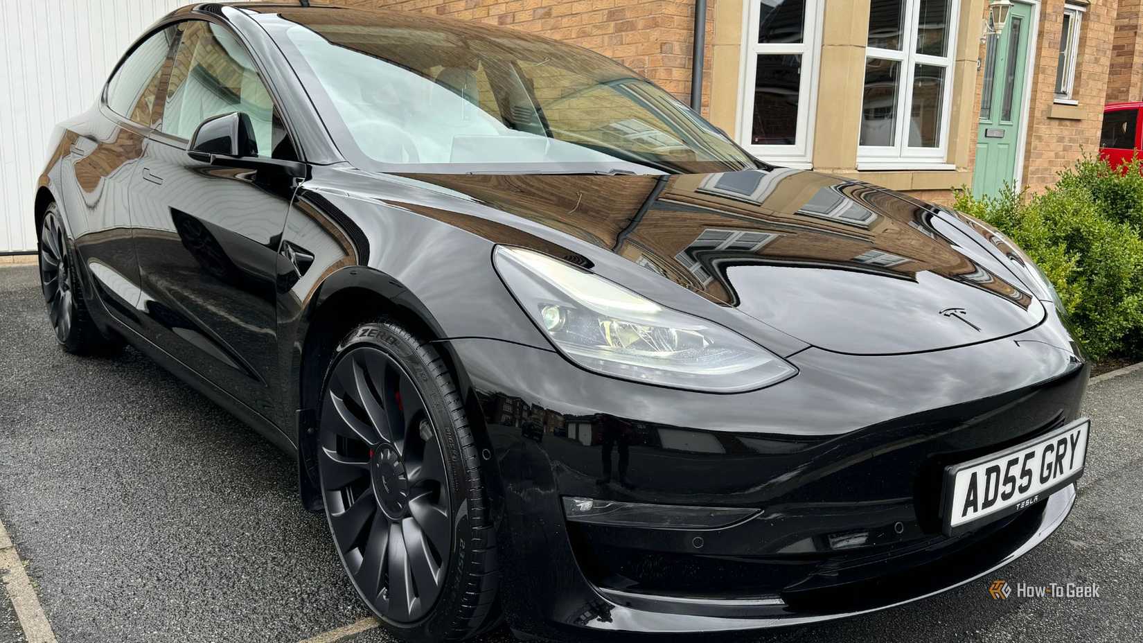 Static front 3/4 shot of a black 2021 Tesla Model 3 Performance.