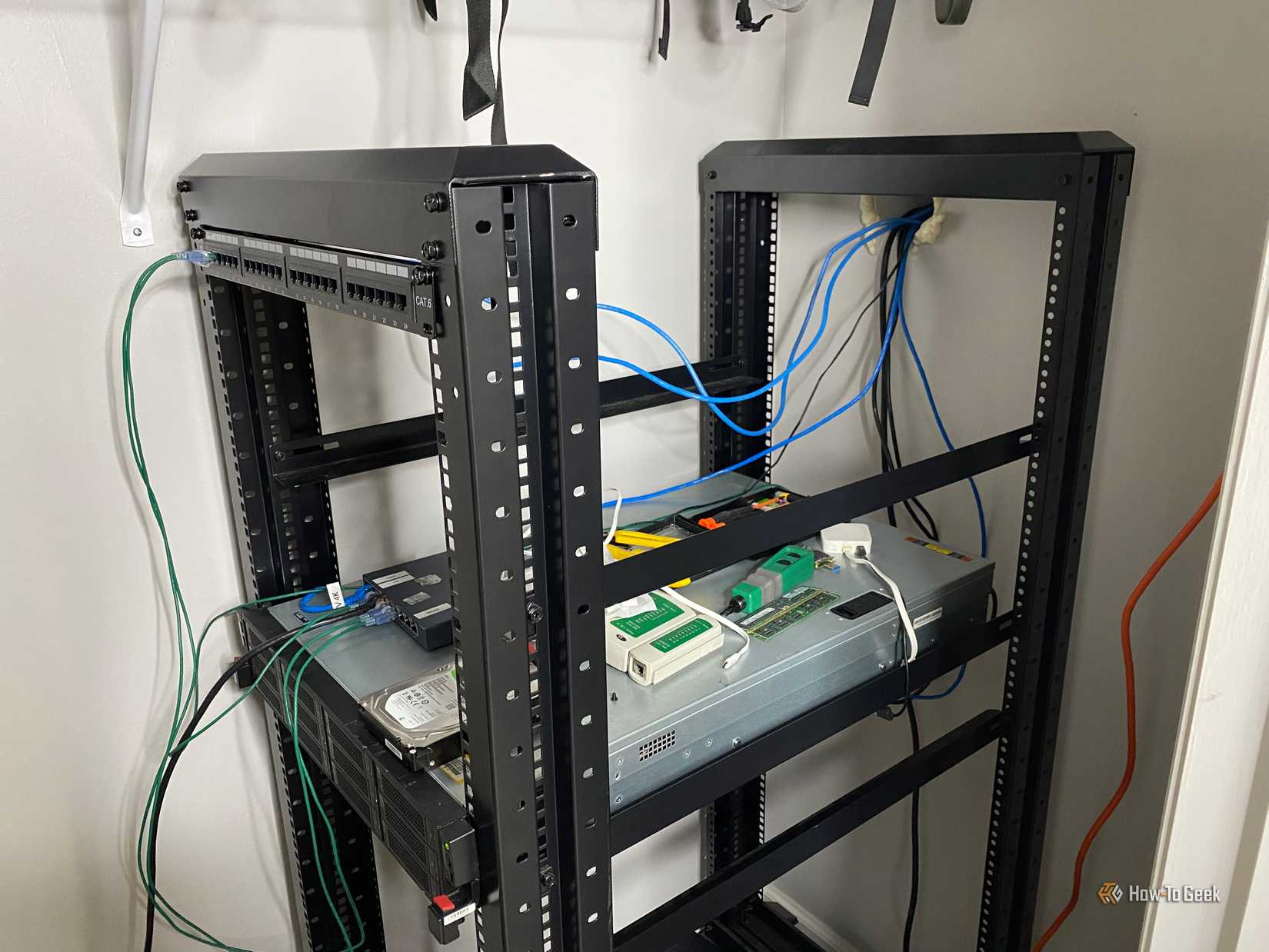 A server rack with a server and network patch panel in it.