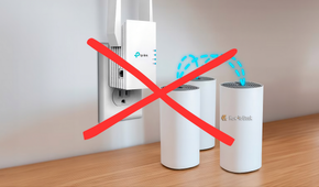 A Wi-Fi extender mounted on the wall with three mesh routers arranged above a desk, showing a home network setup for better coverage.
