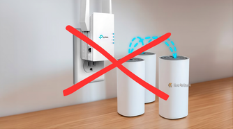 A Wi-Fi extender mounted on the wall with three mesh routers arranged above a desk, showing a home network setup for better coverage.