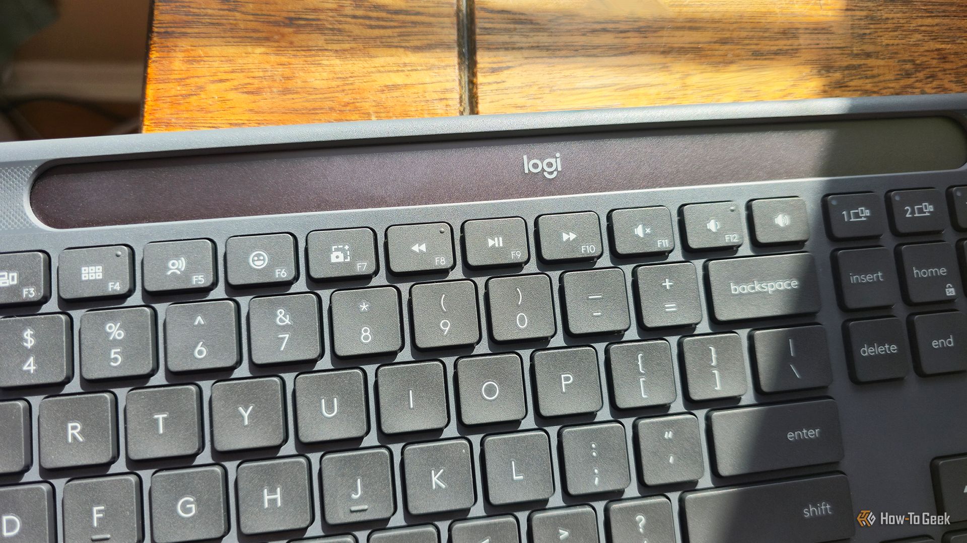 The Logitech Signature Slim Solar+ K980 wireless keyboard charging in the sun.