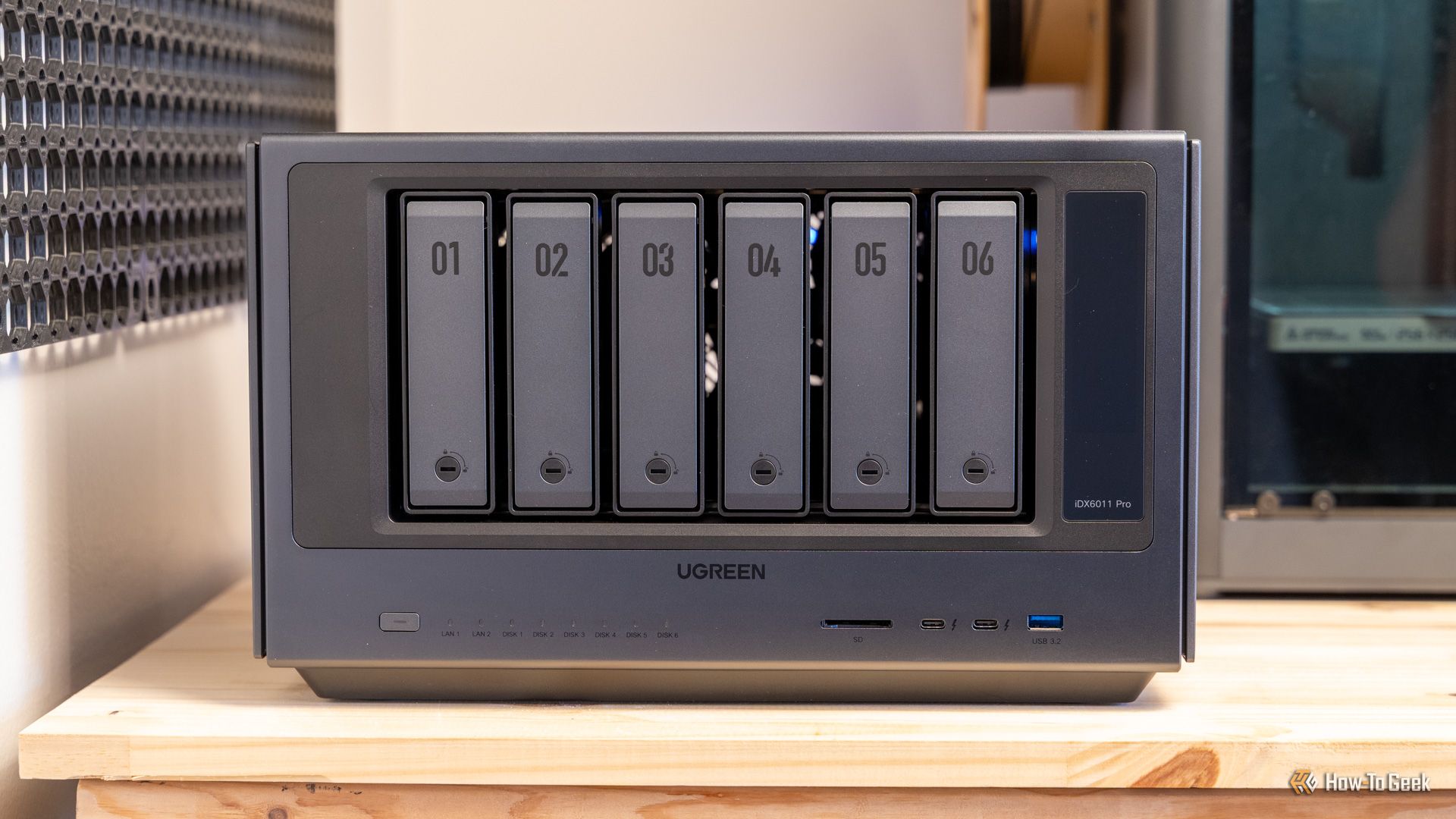 The Ugreen iDX6011 Pro NAS front panel showing all six numbered drive bays and connectivity ports.