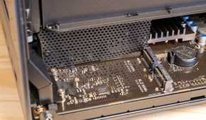 The Ugreen iDX6011 Pro NAS interior with the bottom panel removed showing the full motherboard and M.2 slots.