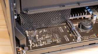 The Ugreen iDX6011 Pro NAS interior with the bottom panel removed showing the full motherboard and M.2 slots.